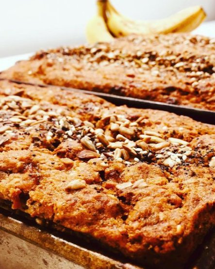 Trays of home-baked banana bread with a seed topping, fresh from the oven