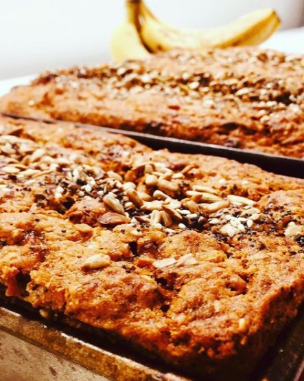 Trays of home-baked banana bread with a seed topping, fresh from the oven